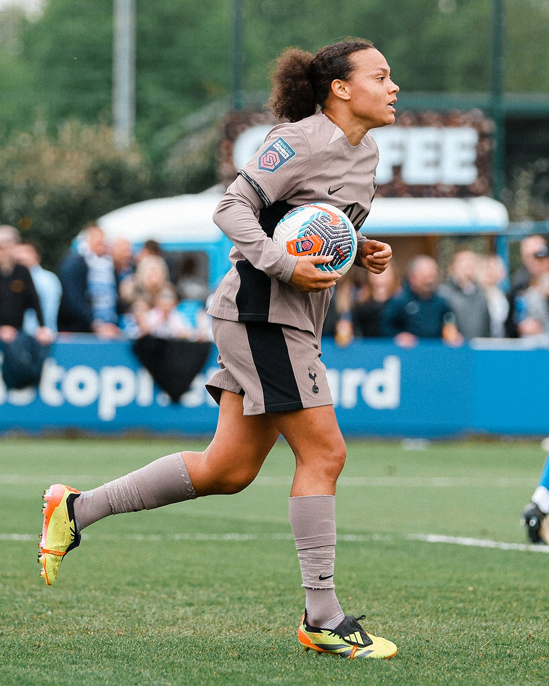 Drew Spence carries the ball back to the center circle to resume the game after scoring.