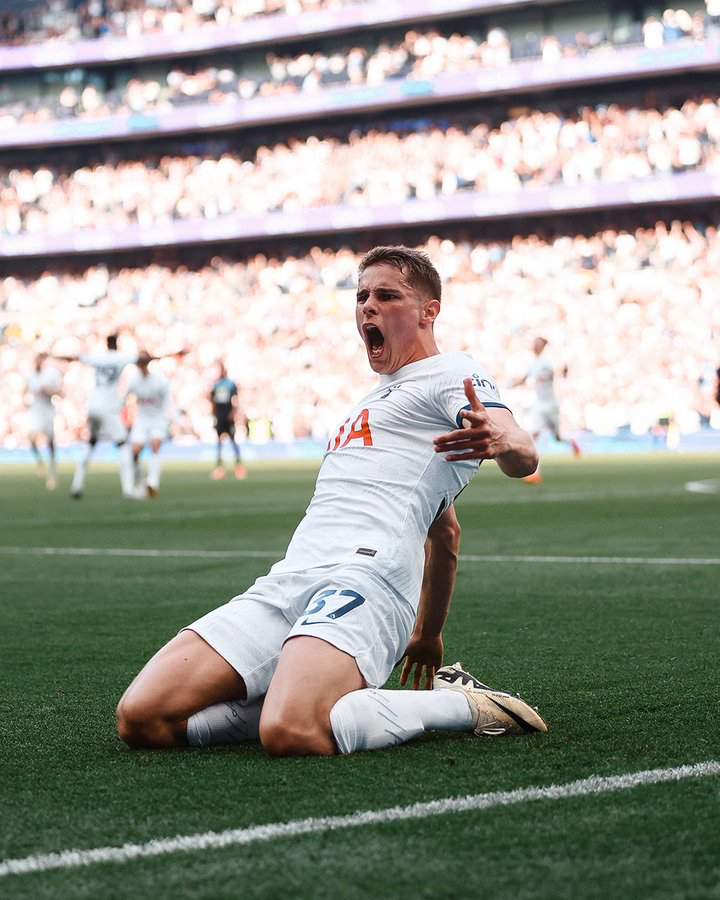 Micky van de Ven knee slides to celebrate his game-winning goal.