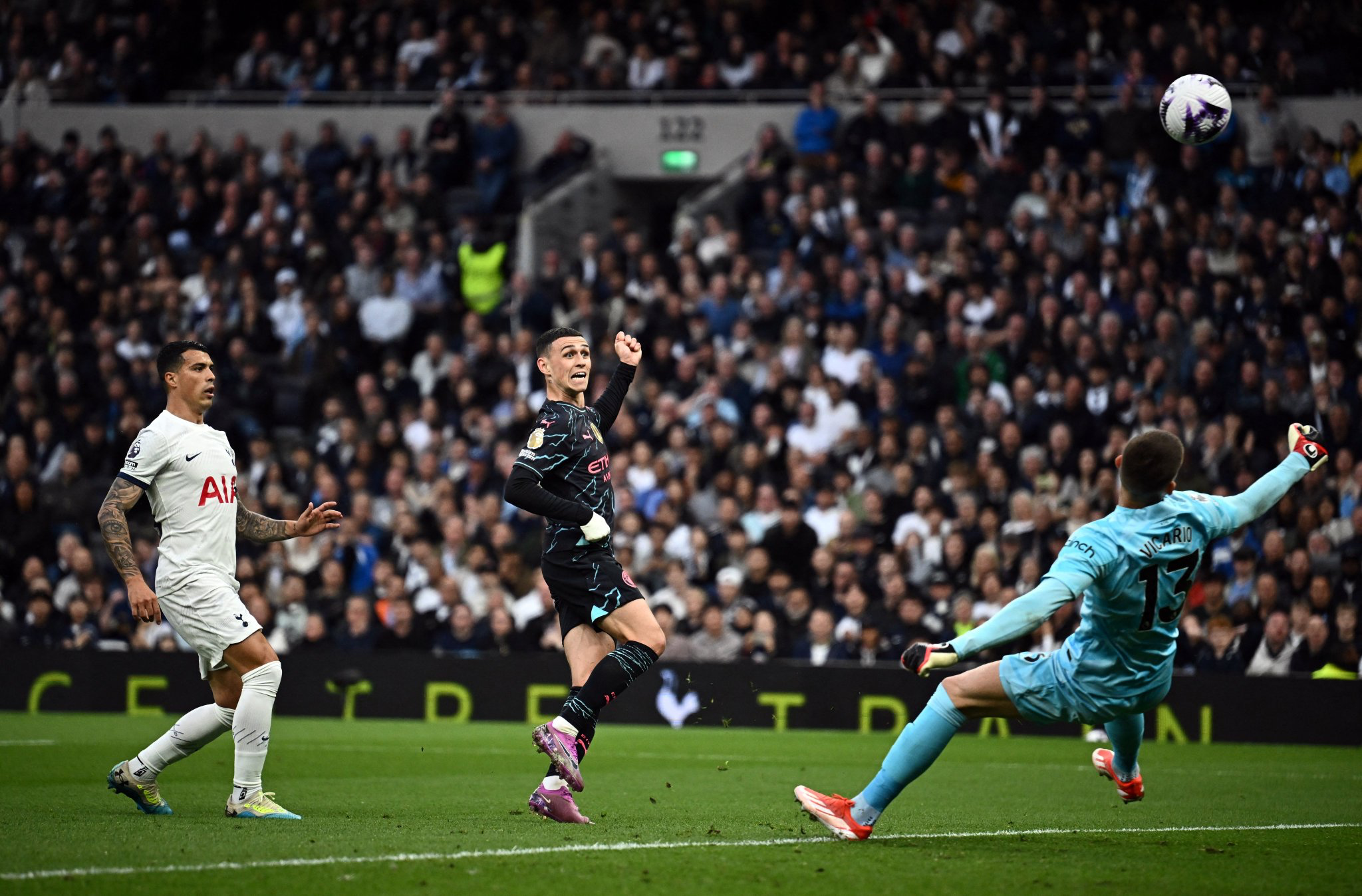Guglielmo Vicario makes a footed save on Phil Foden's shot.