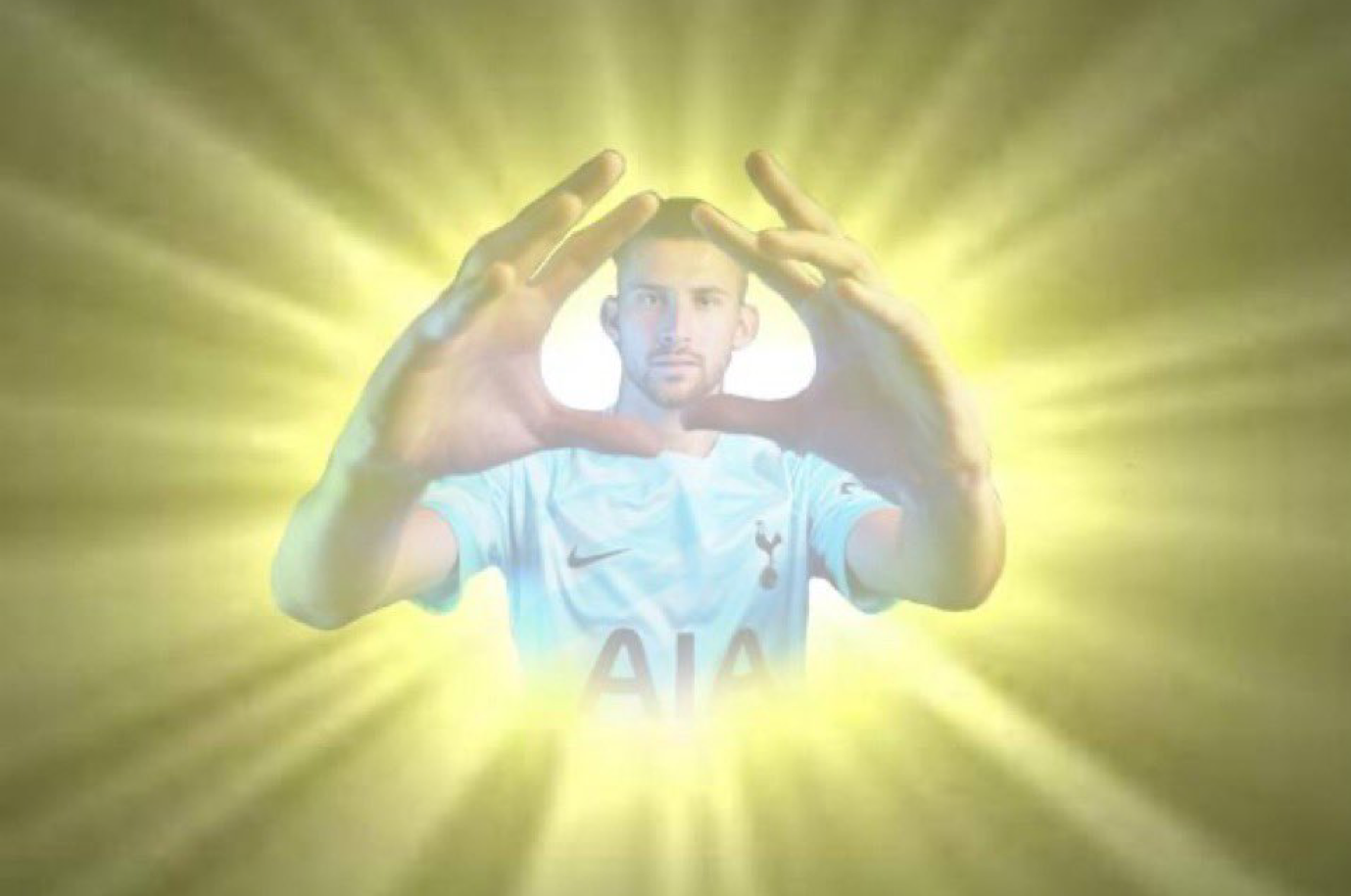 Guglielmo Vicario with his hands help up together, framing his face, while a heavenly glow emits from behind him.