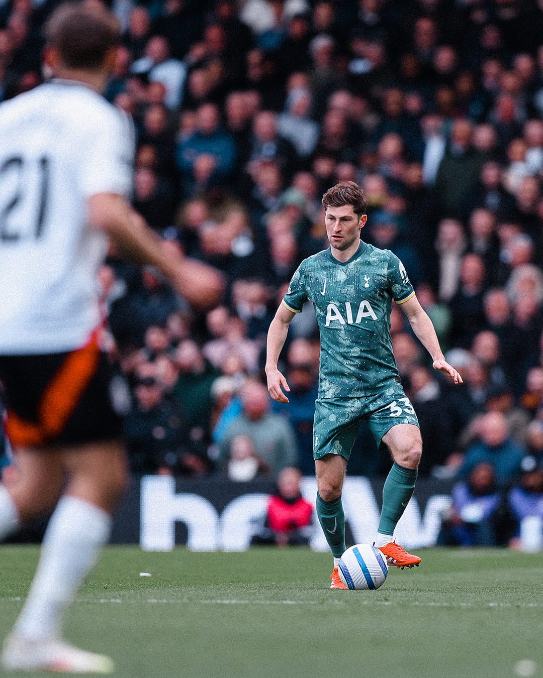 Ben Davies stands poised to pass the ball.