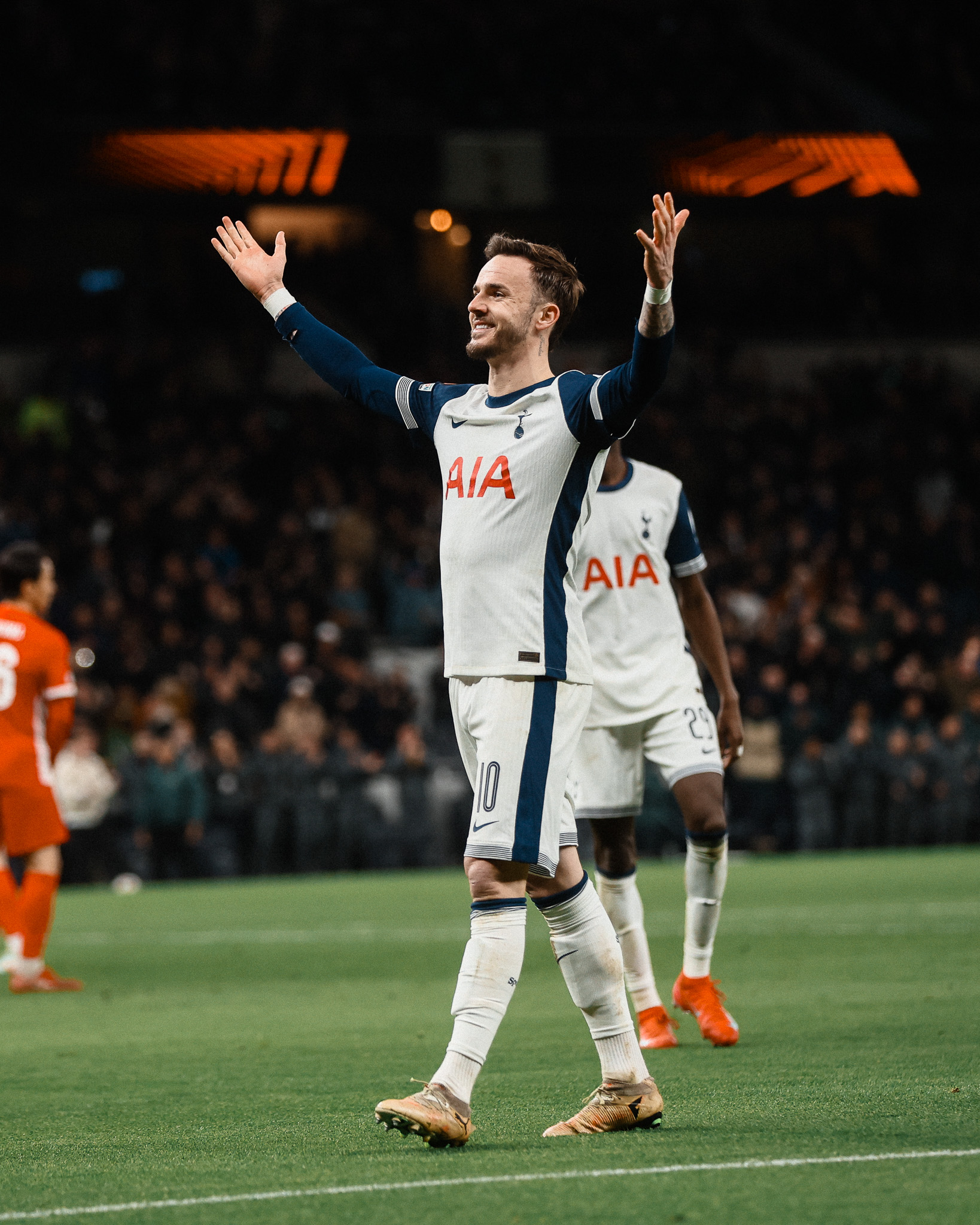 James Maddison raises his arms in celebration.