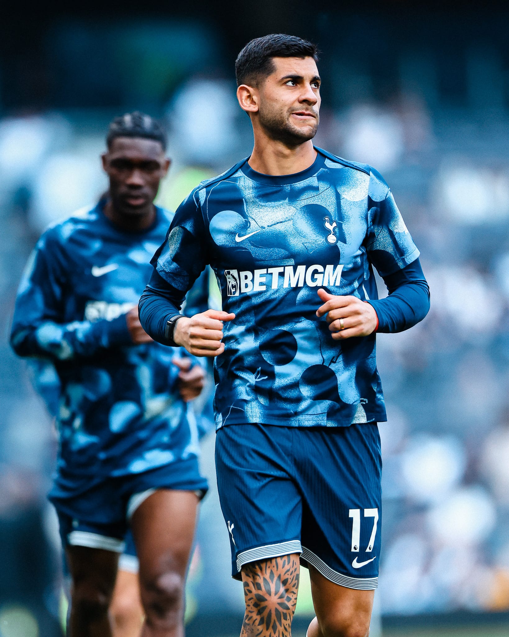 Cristian Romero grimaces as he looks into the distance during the warm-up.