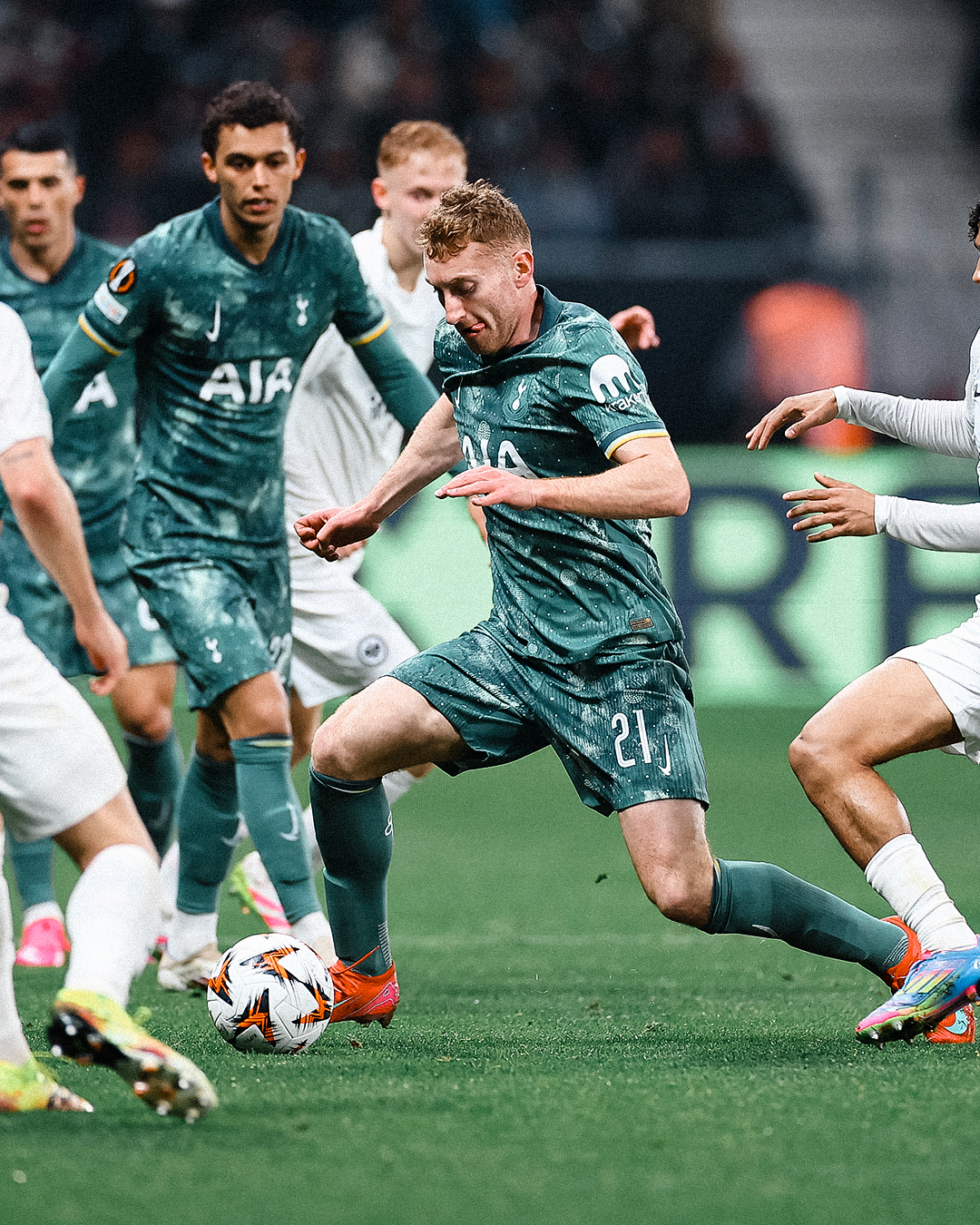 Dejan Kulusevski dribbles the ball, surrounded by several players, both teammates and opposition. 