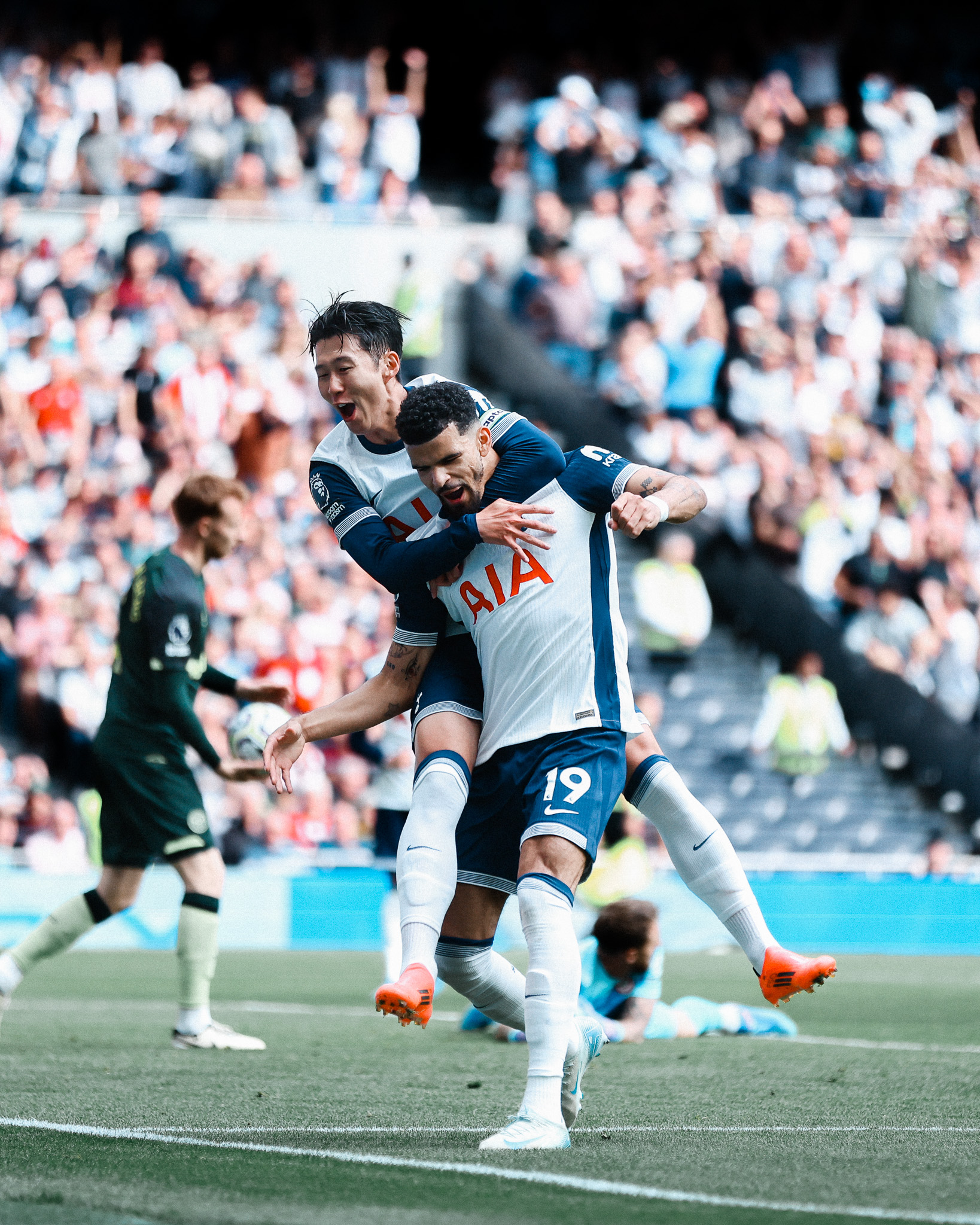Son Heung-min jumps on Dominic Solanke's back to celebrate the latter's goal.