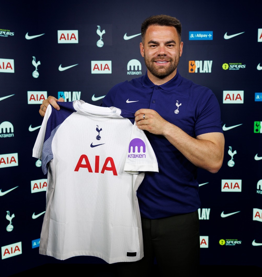 Martin Ho smiles and holds up a Spurs 2025/26 home shirt.