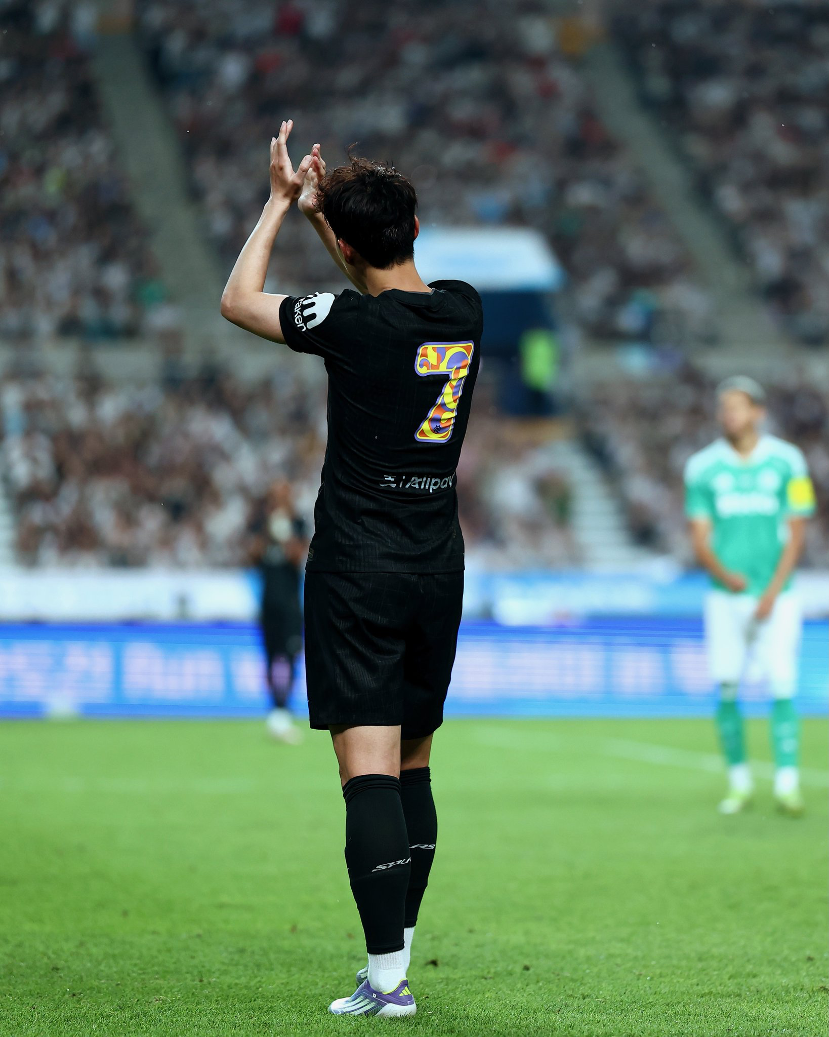 Son Heung-min claps to the fans as he leaves the pitch.