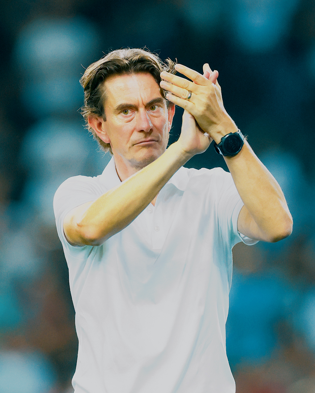 Thomas Frank claps towards the fans.