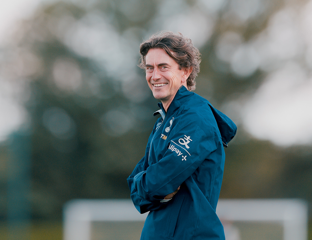 Thomas Frank smiles in his windbreaker on the training pitch.
