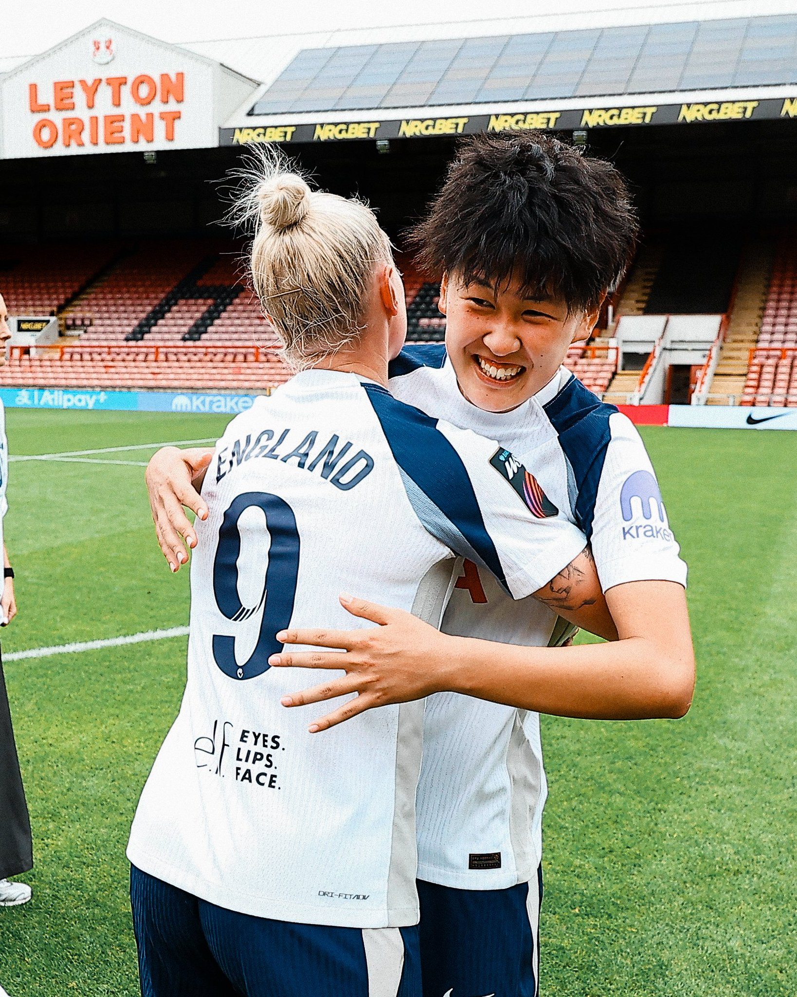 Tōko Koga smiles broadly as Beth England hugs her after the game.