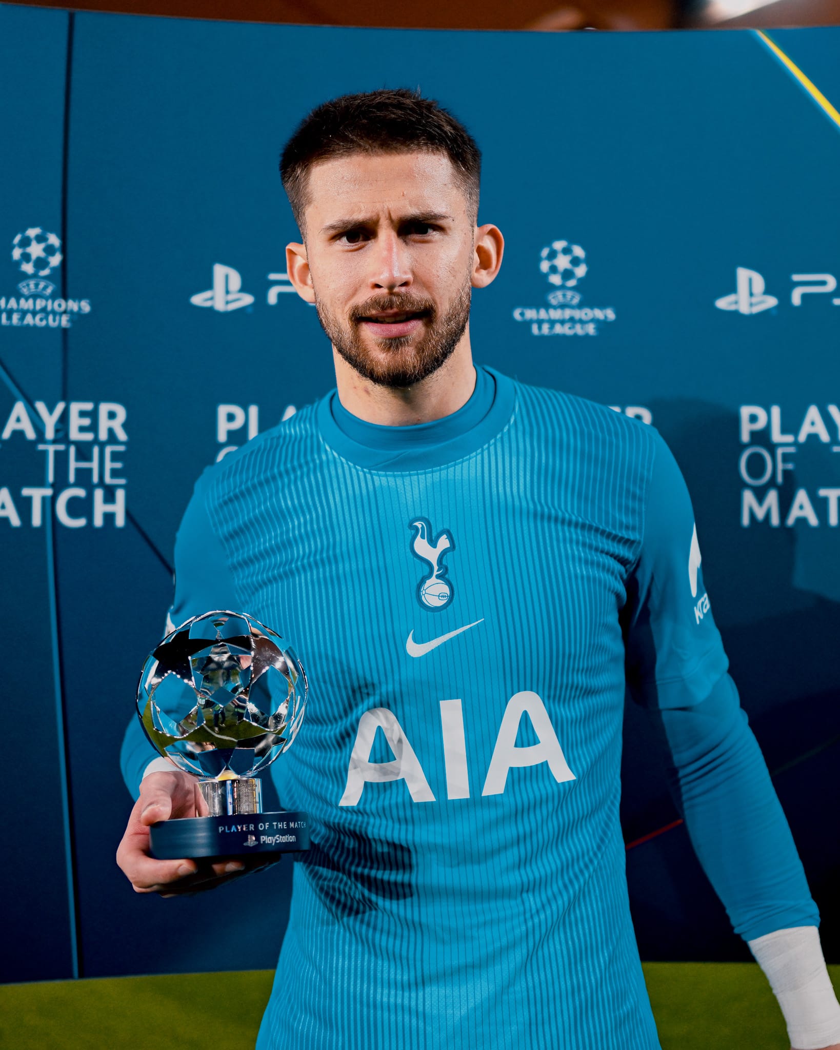 Guglielmo Vicario poses with his Player of the Match trophy.
