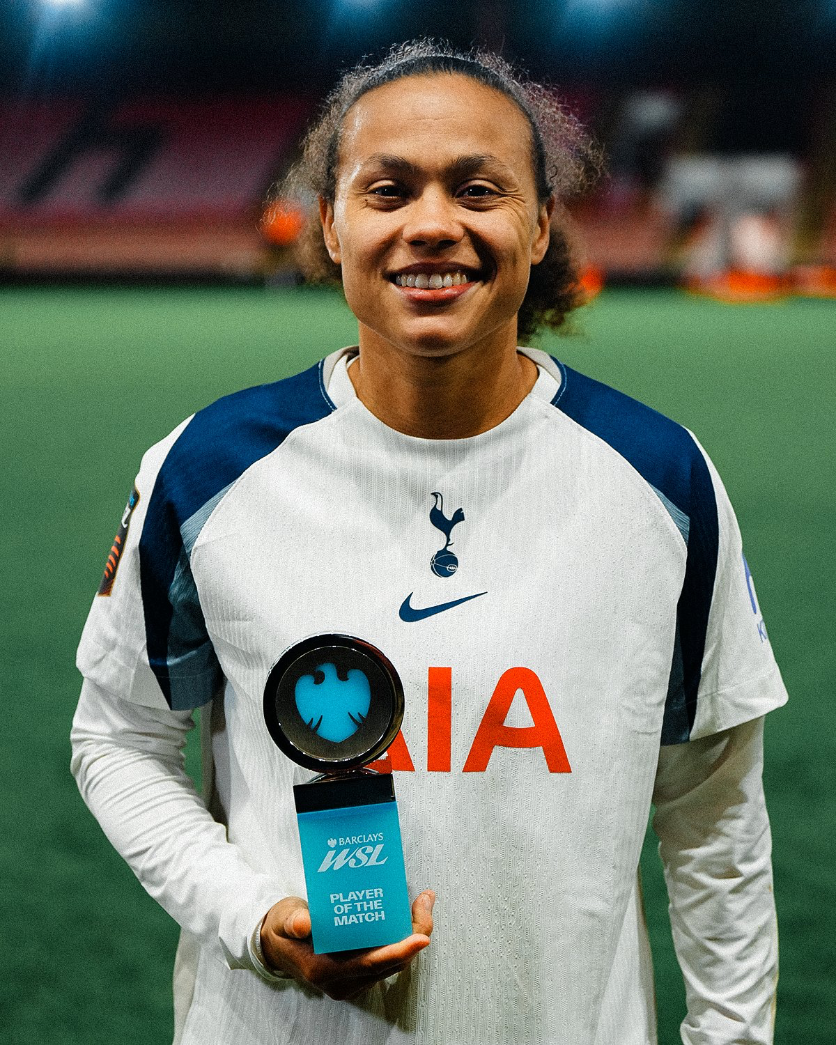 Drew Spence holds up her Player of the Match award.