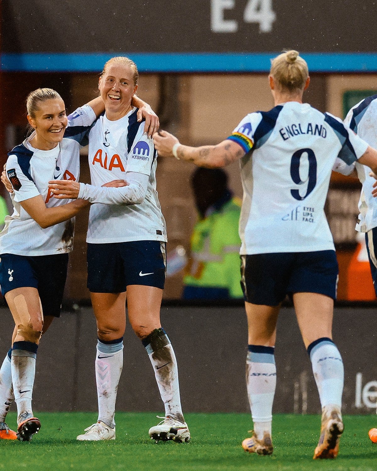 Eveliina Summanen smiles with Amanda Nildén's arm around her shoulder, as Beth England jogs towards them wtih arms spread wide.