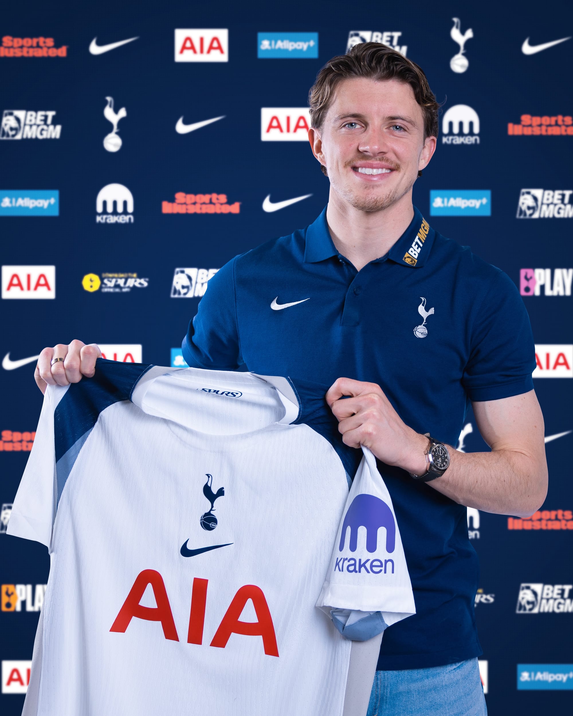 Conor Gallagher holds up his new Spurs kit.