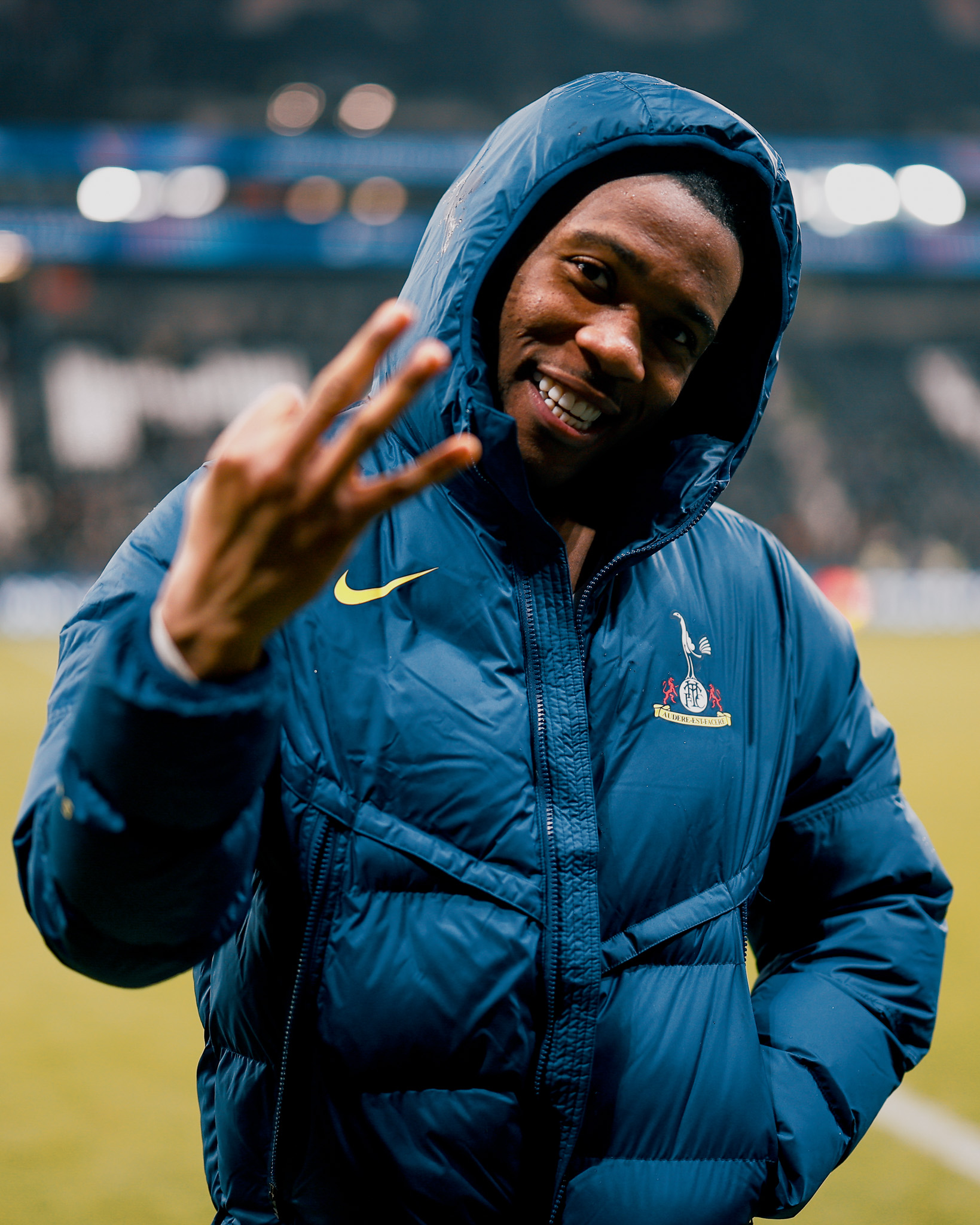 Destiny Udogie, hood up, holds up three fingers after the win. 