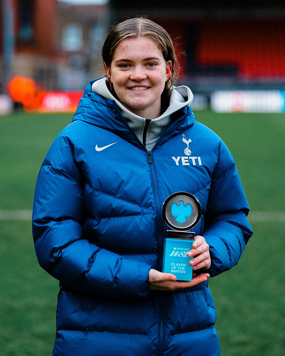 Signe Gaupset smiles and holds up her Player of the Match award.