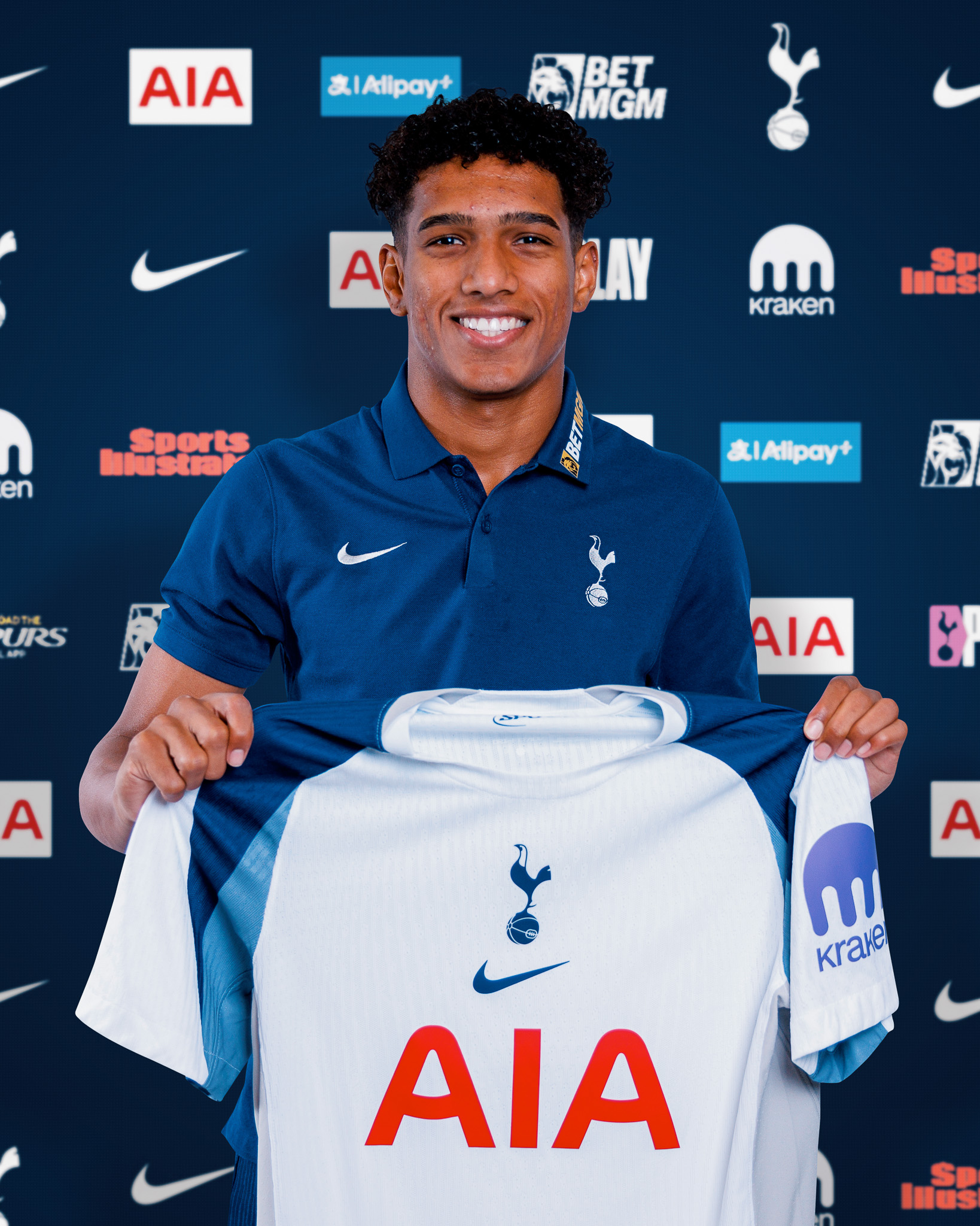 Souza holds up his first Spurs shirt.