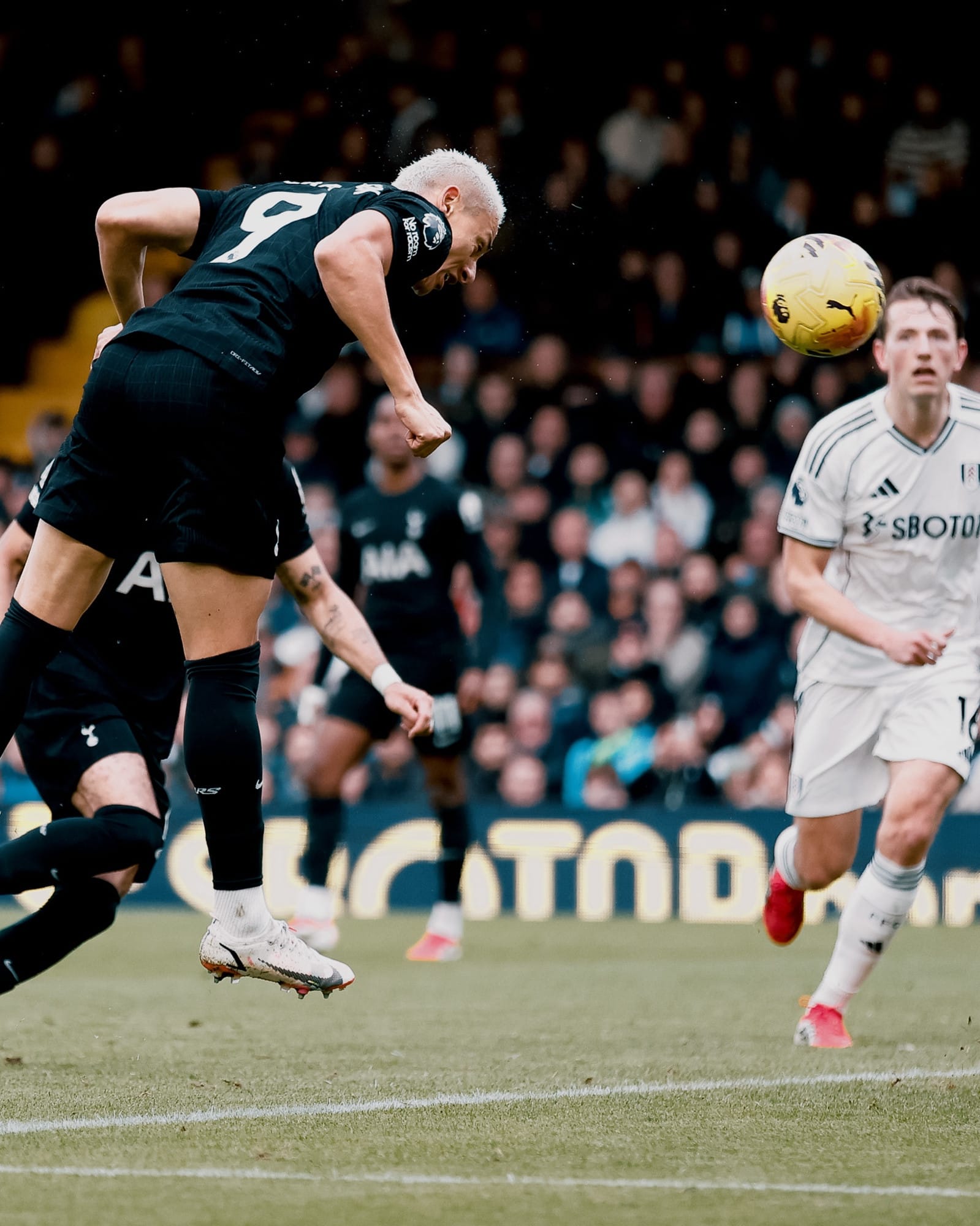 Richarlison heads the ball.