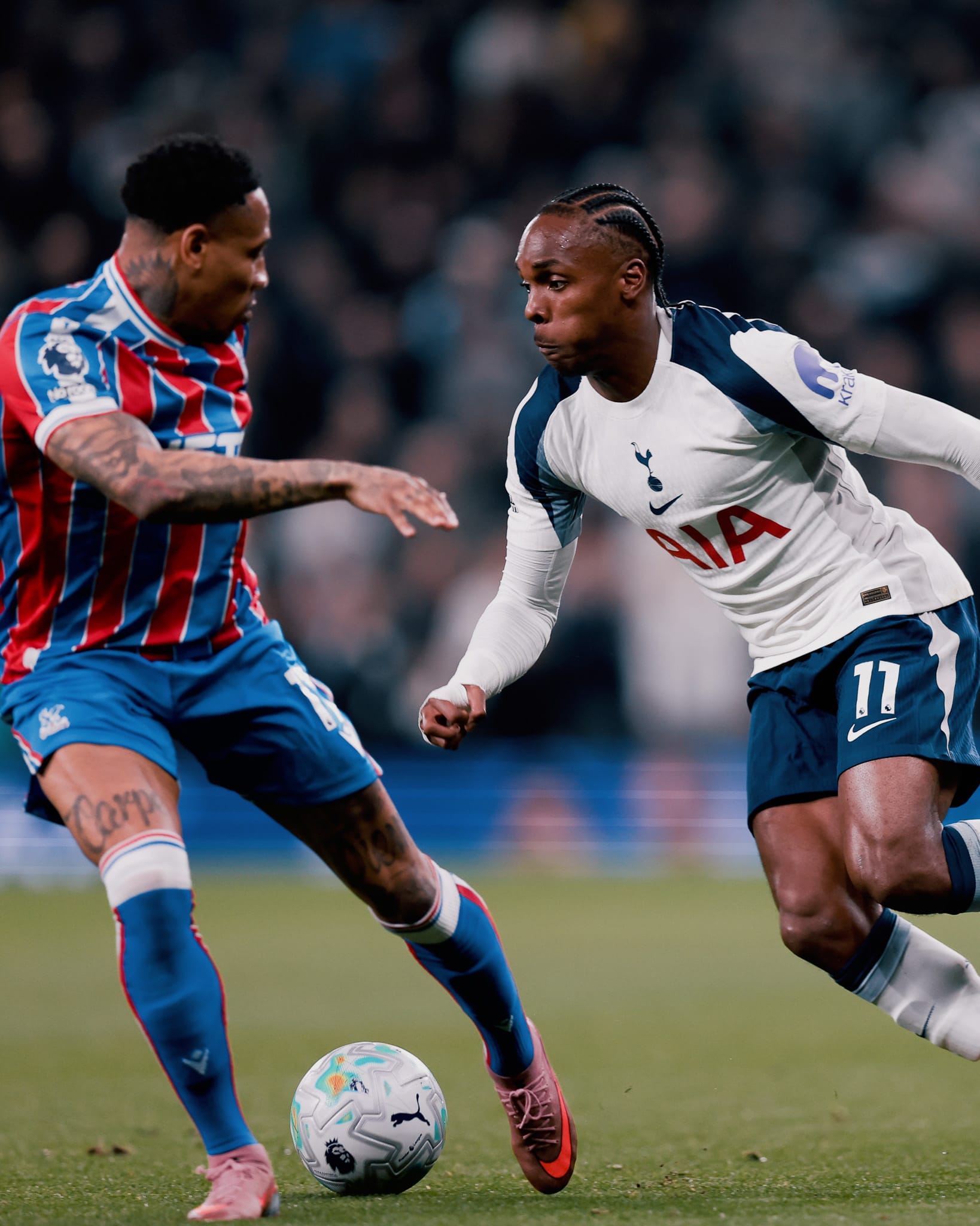 Mathys Tel challenges Nathaniel Clyne for the ball.