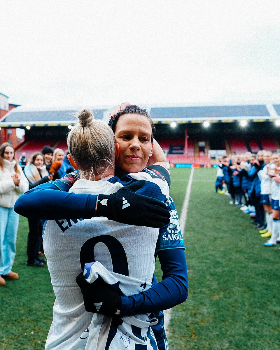 Ash Neville hugs Beth England after receiving a guard of honor from her old teammates.