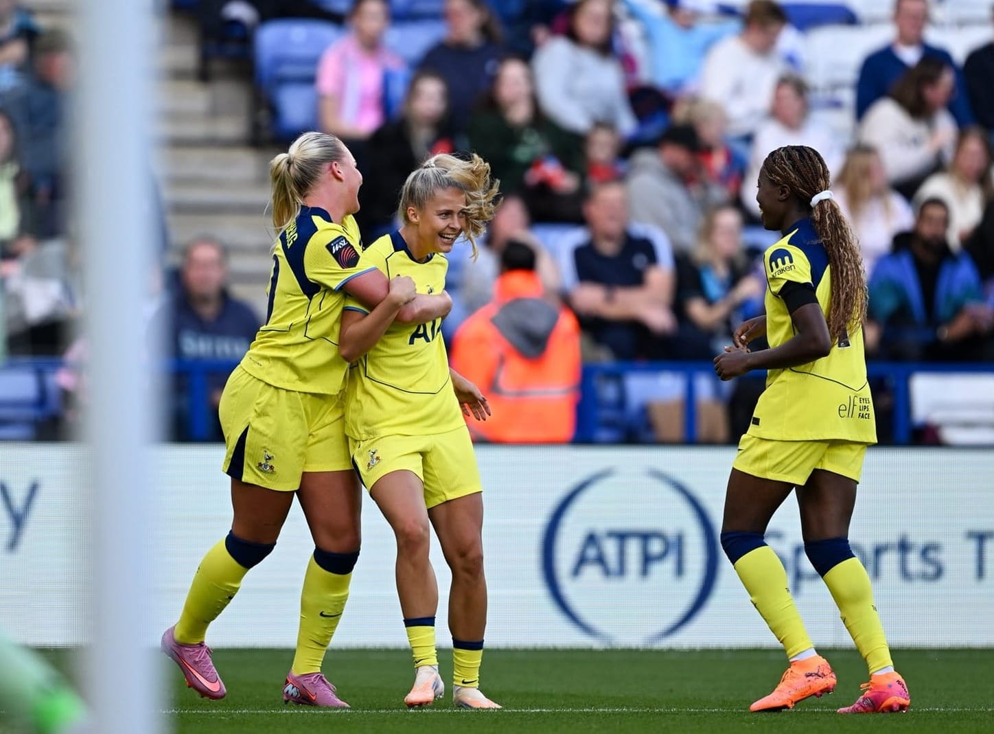 Olivia Holdt is hugged by Tinka as Jess Naz jogs over to celebrate with them.