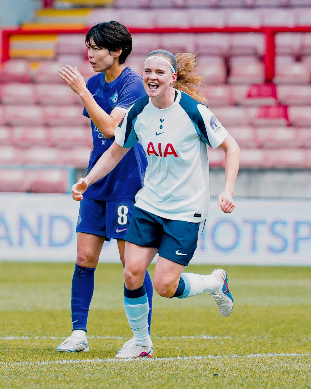 Signe Gaupset smiles after scoring, Saki Kumagai behind her.