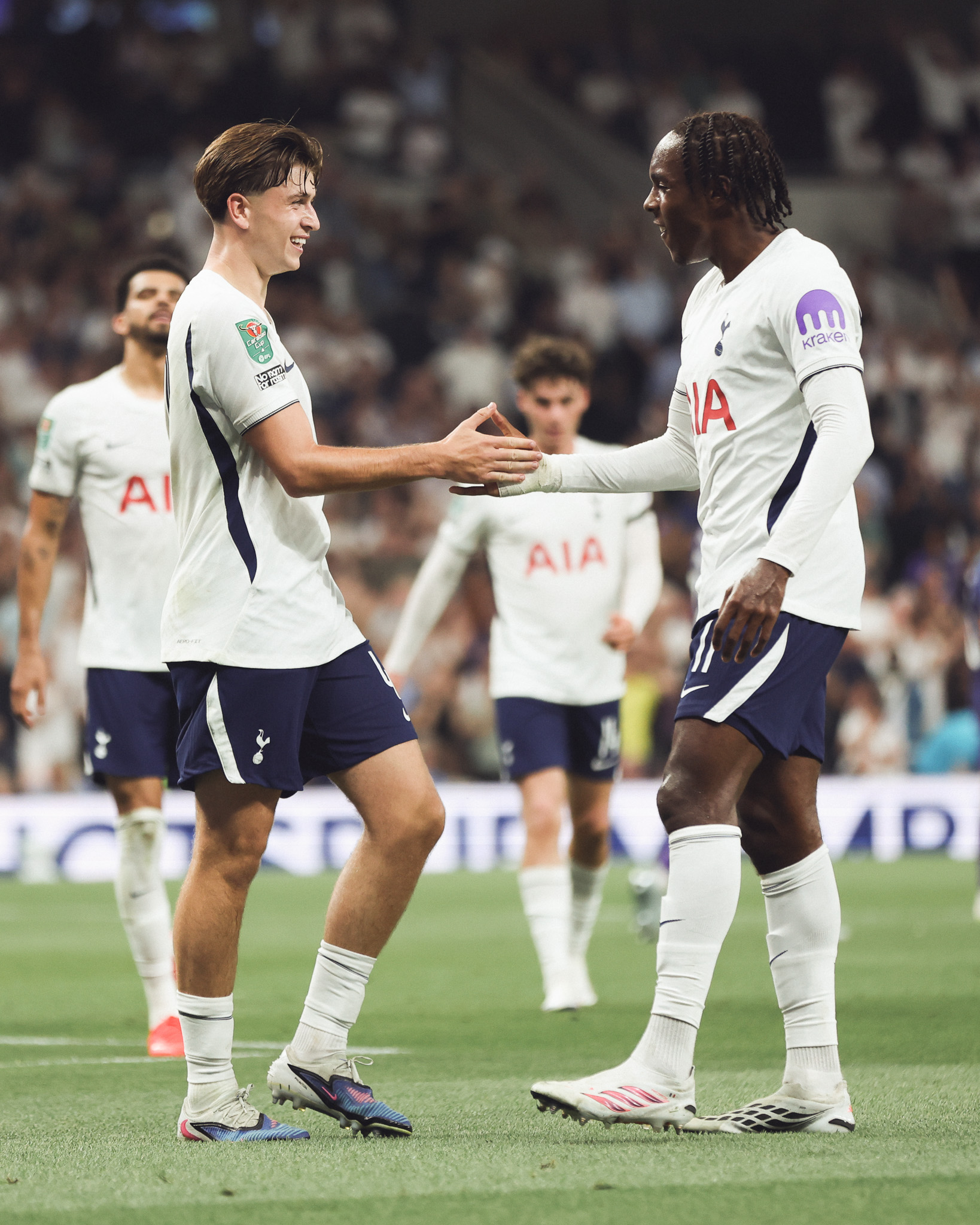 Mikey Moore shakes hands with Mathys Tel after scoring.