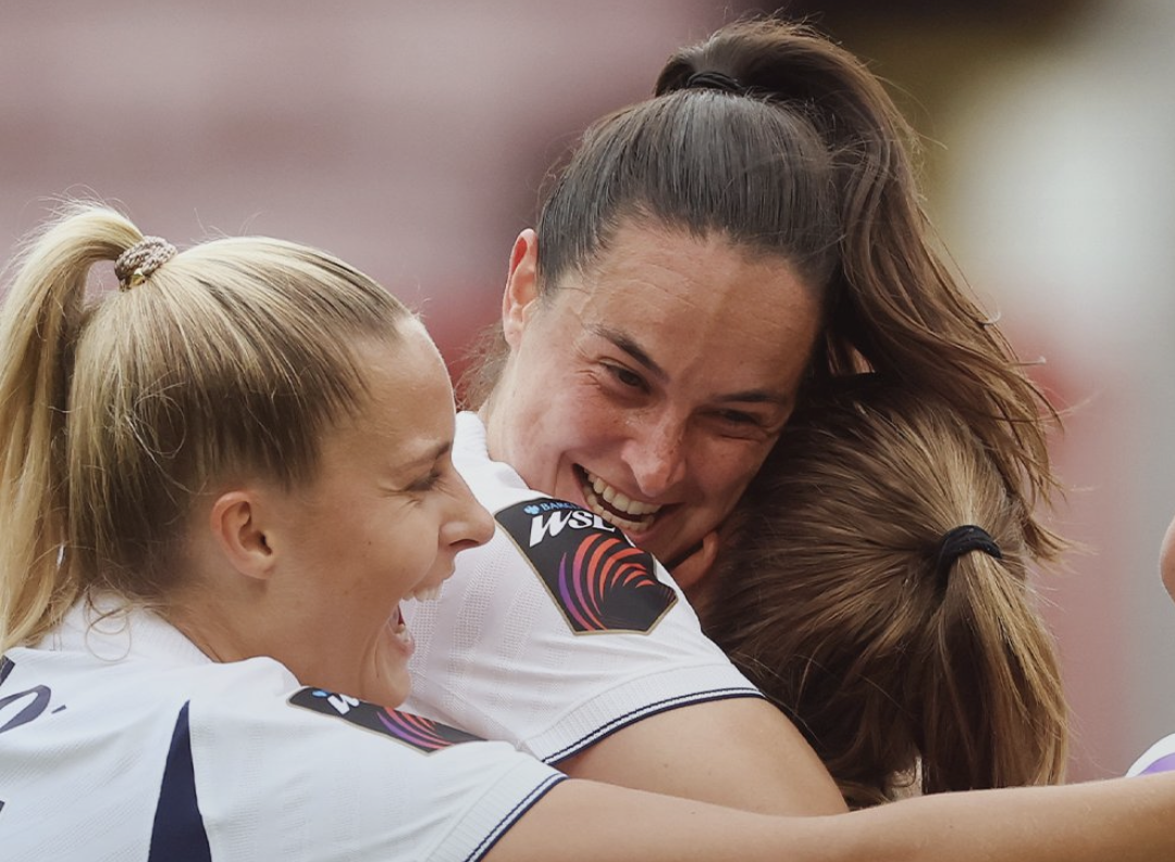 Cailtin Dijkstra jumps on a teammate to celebrate her first Spurs goal.