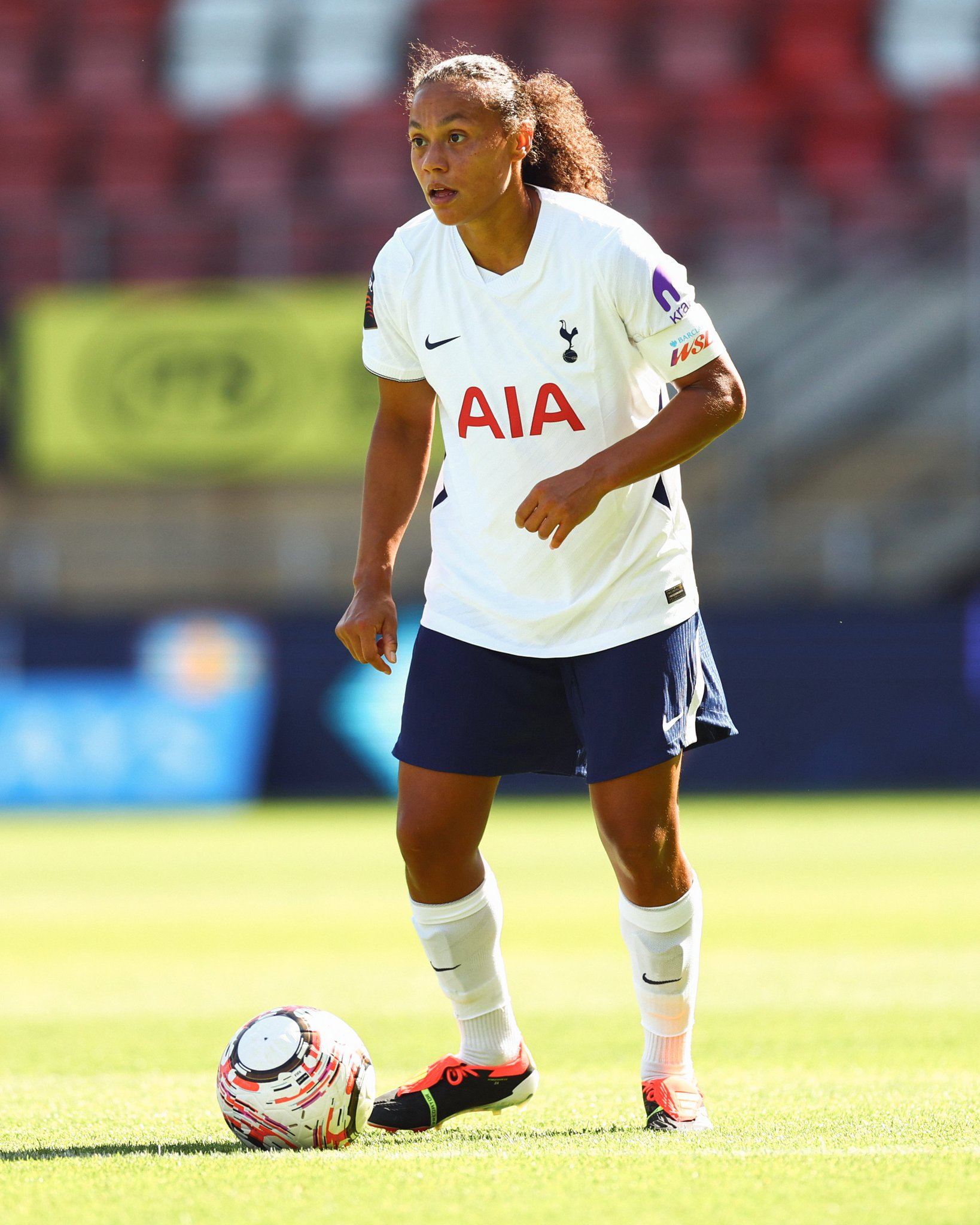 Drew Spence scans the pitch with the ball at her feet.