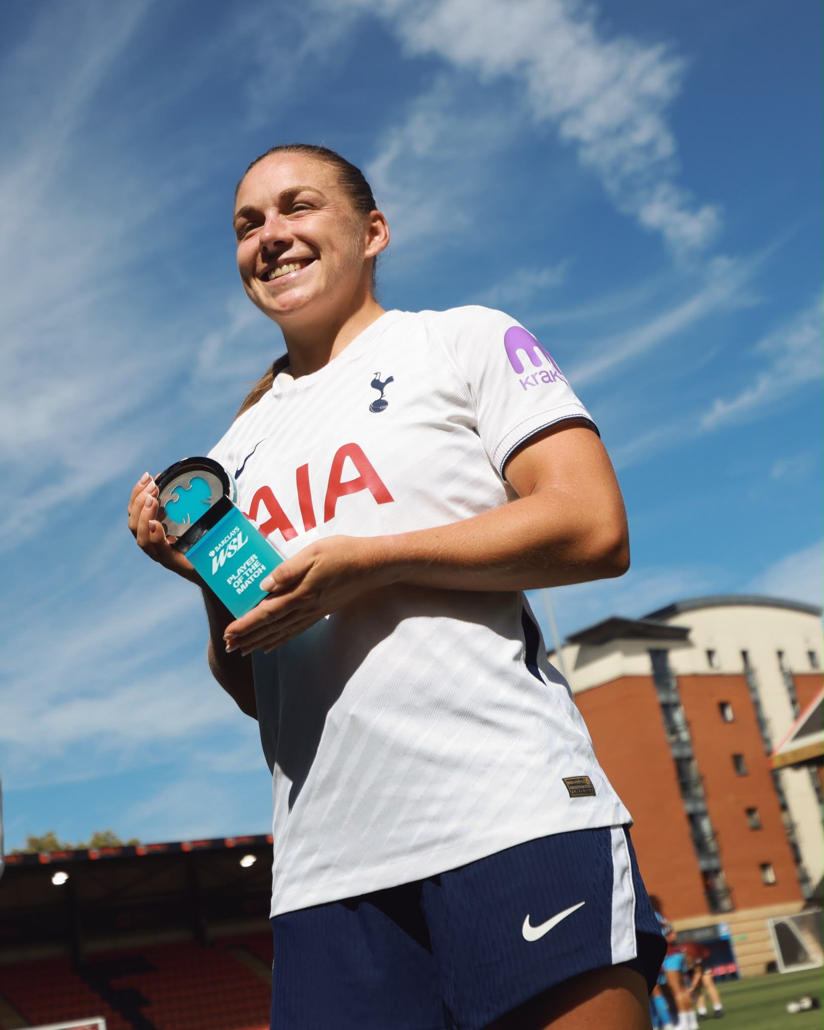Kirsty Hanson shows off her Player of the Match award with a big smile on her face.