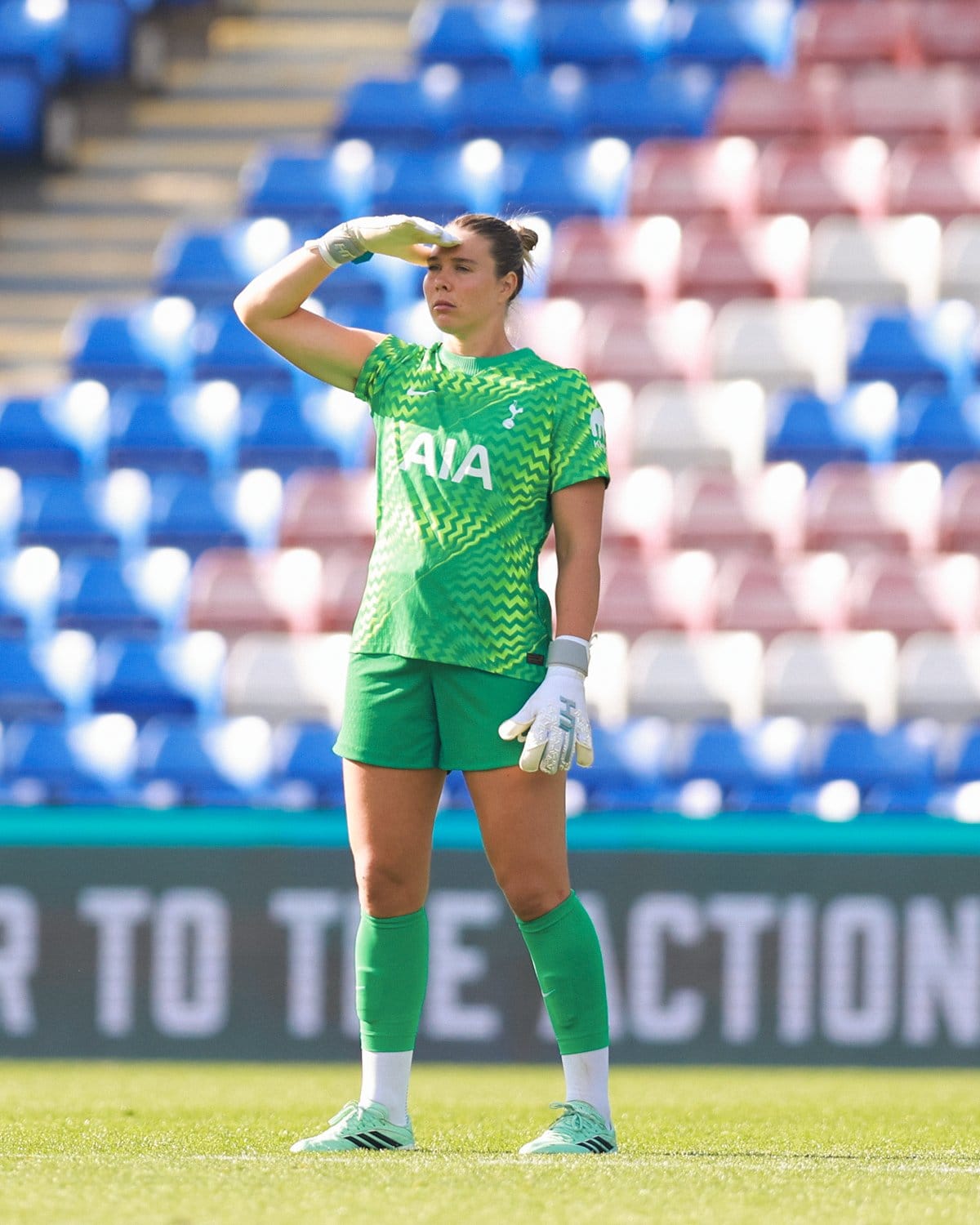 Lize Kop scans the pitch with her hand shielding her eyes from the sun.
