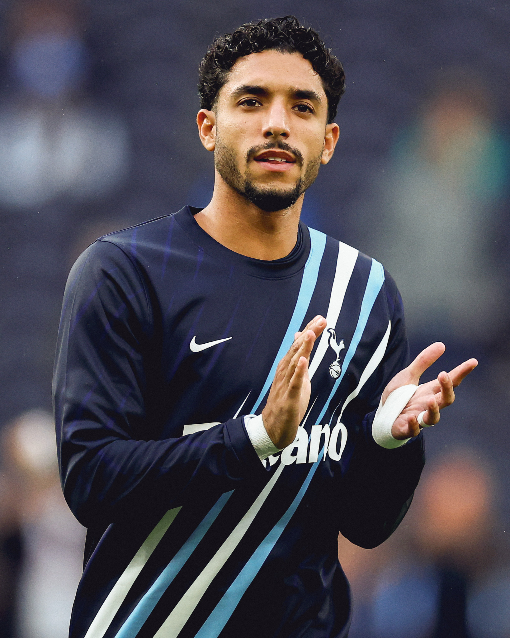 Omar Marmoush claps in his warmup kit.