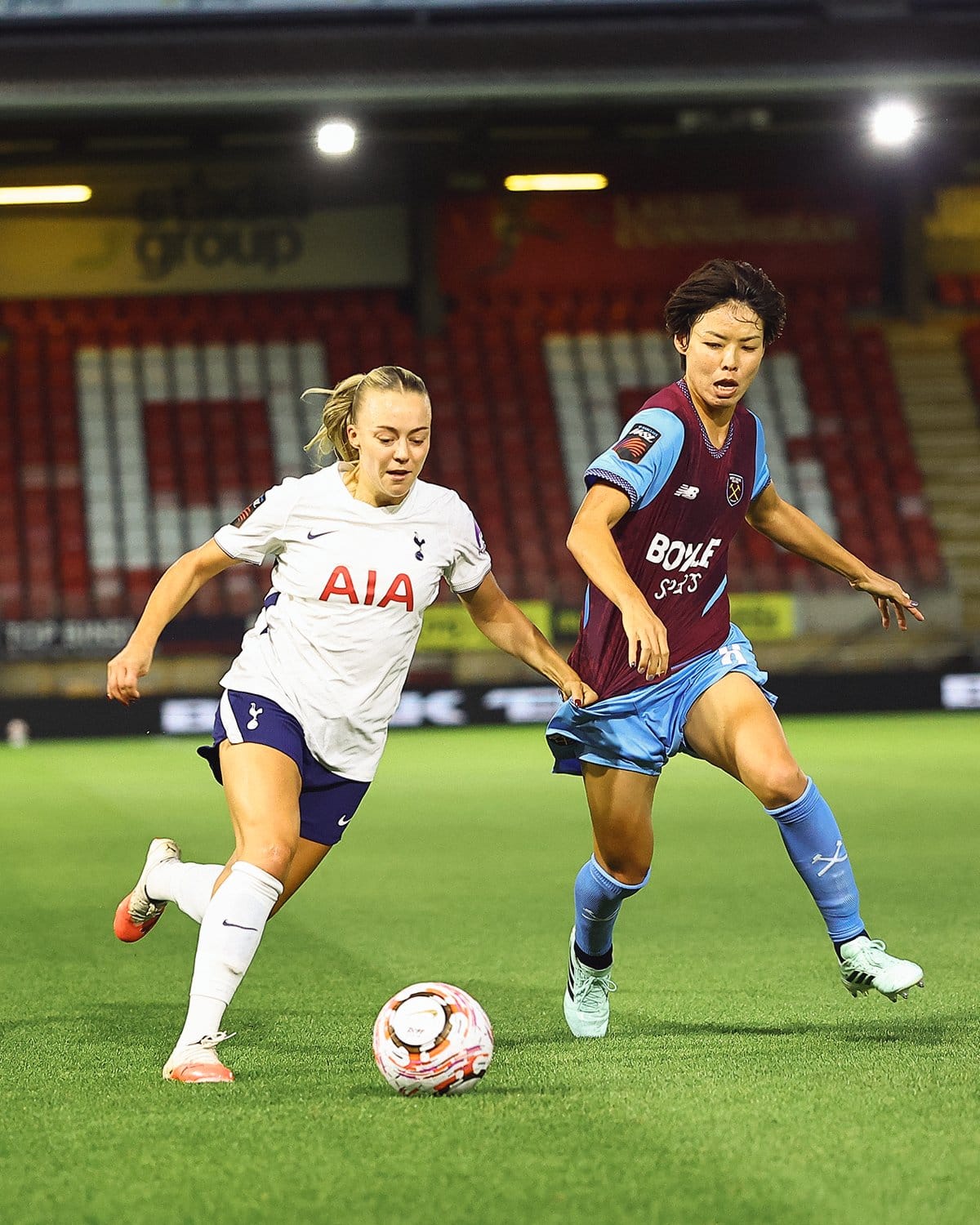 Olga Ahtinen challenges Saki Kumagai for the ball.