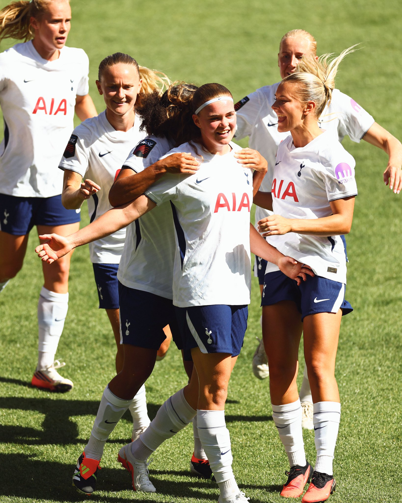 Signe Gaupset is embraced by teammates after scoring.
