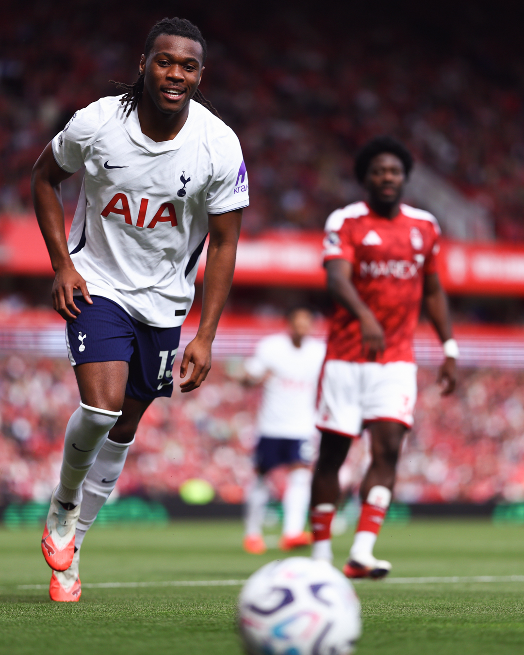 Destiny Udogie smiles as he chases down the ball.