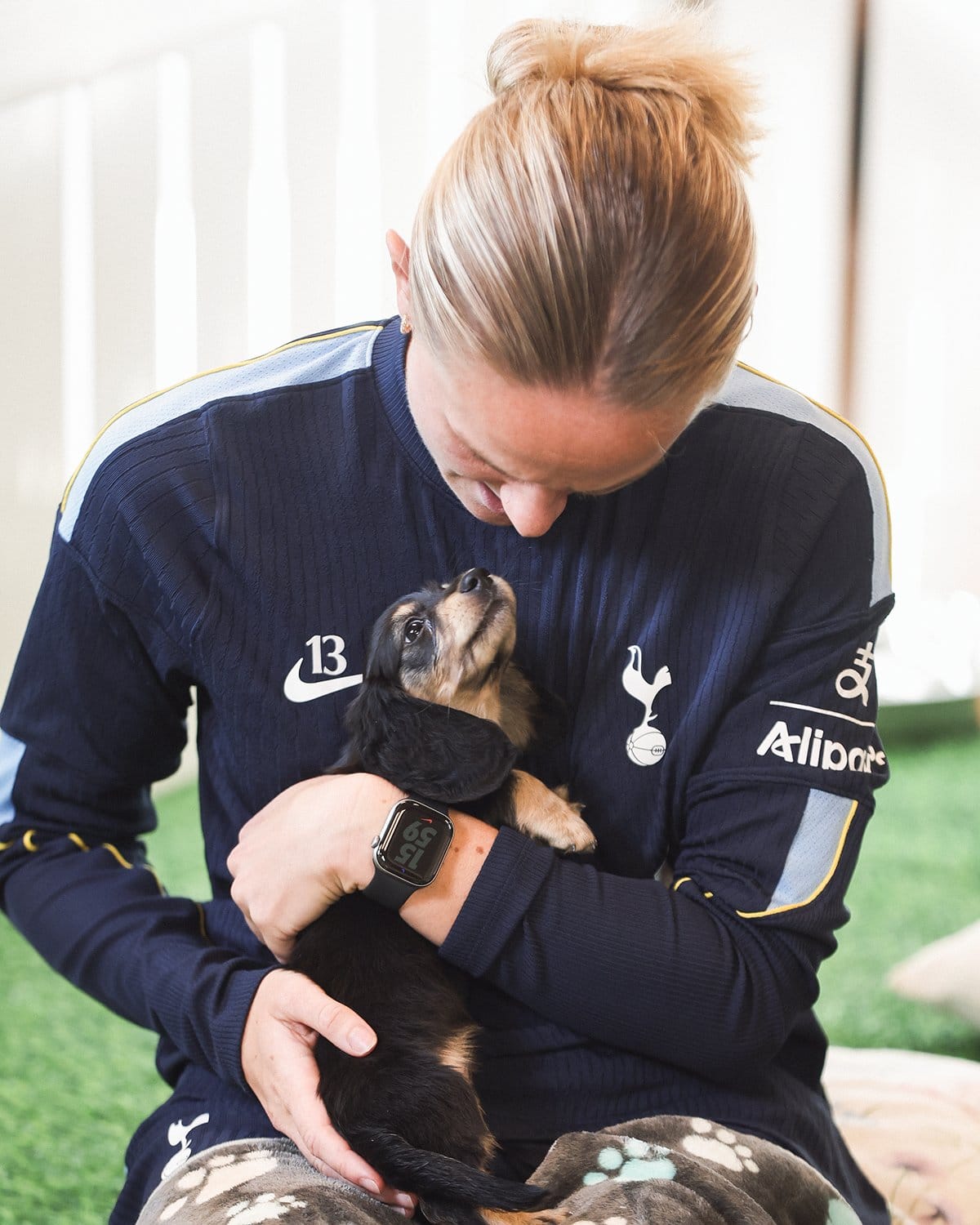 Matilda Vinberg gazes down at a puppy gazing up at her with love.