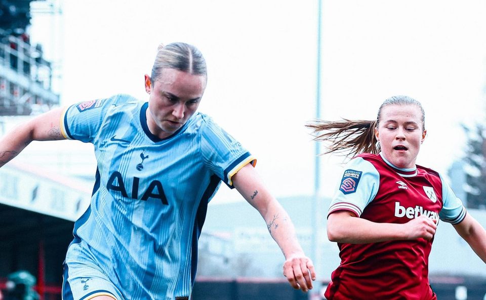 Martha Thomas challenges a West Ham player for the ball.