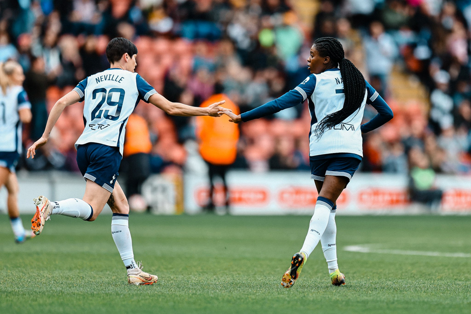 Running back to center circle, Ash Neville high fives Jess Naz after the latter's goal against Aston Villa.
