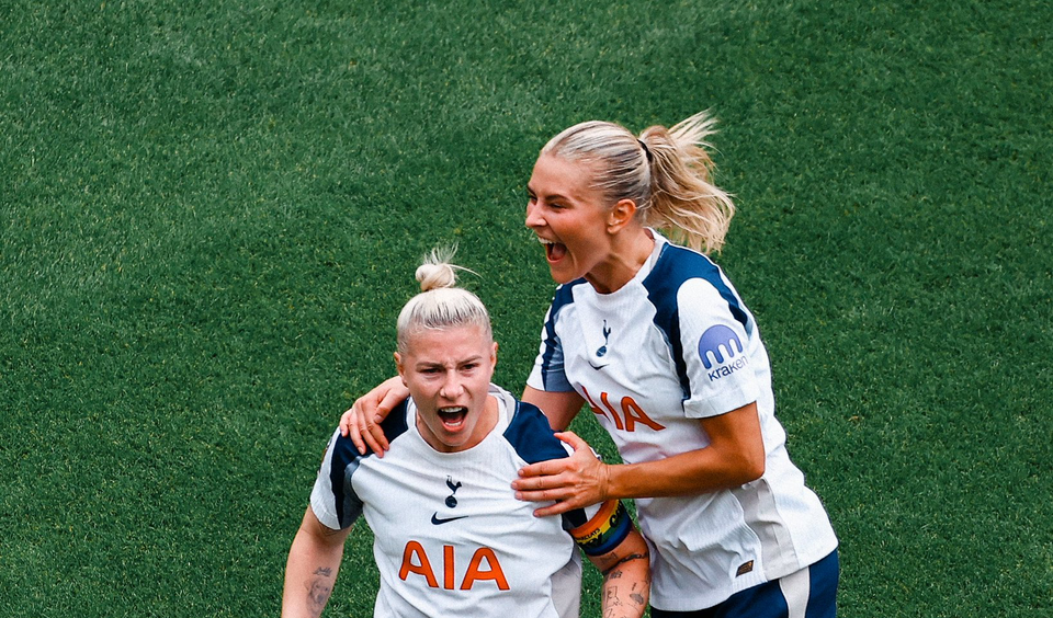 Amanda Nildén jumps on Beth England's shoulders to celebrate the latter's penalty goal.