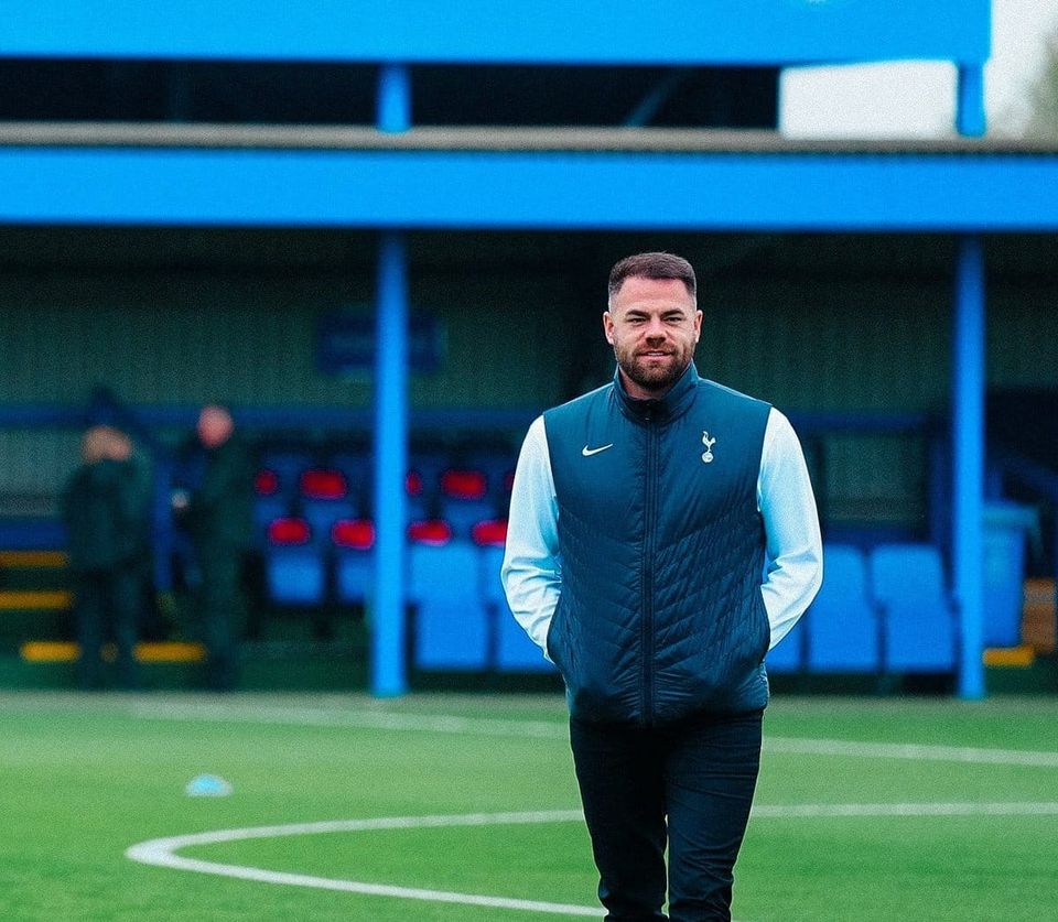 Martin Ho smiles in his Spurs vest on the pitch at Kingsmeadow.