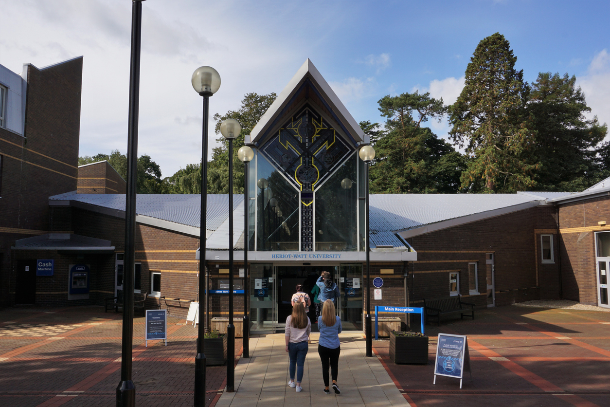Riccarton Campus, Edinburgh, Scotland - 05 September 2020: A number of visitors are walking towards the main reception building of Heriot-Watt University sited on the Riccarton Campus on the outskirts of Edinburgh.
