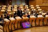 Deputy first minister John Swinney addresses the Scottish Parliament surrounded by MSPs.
