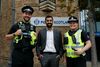 First Miinister Humza Yousaf stands with tow officers from Police Scotland