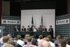 Article: Far right European politicians join Homeland UK conference Image description: a panel discussion featuring seven men