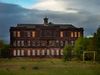 Article headline: Councils sell off 1,600 local assets amidst budget shortfalls Image description: A Derelict School Building