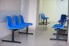 Article: Claim of patients waiting years for NHS treatment is Mostly True Image description: waiting room blue chairs, door o