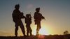 Troops standing in a sunset