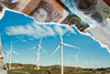 Collage illustration showing British banknotes and coins above a landscape of wind turbines on rolling hills beneath a blue sky with scattered clouds.