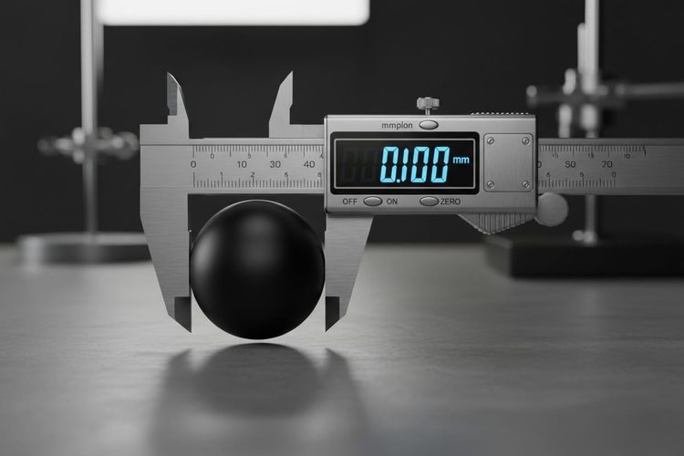  A precision measuring instrument reading zero while attempting to measure a perfect sphere.