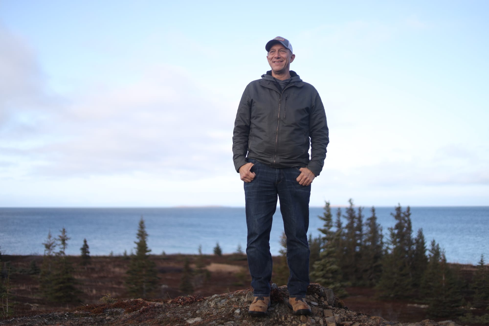 Hill stands above the shore of Iliamna Lake in the village of Kokhanok, where he grew up. (Nathaniel Herz/Anchorage Press)
